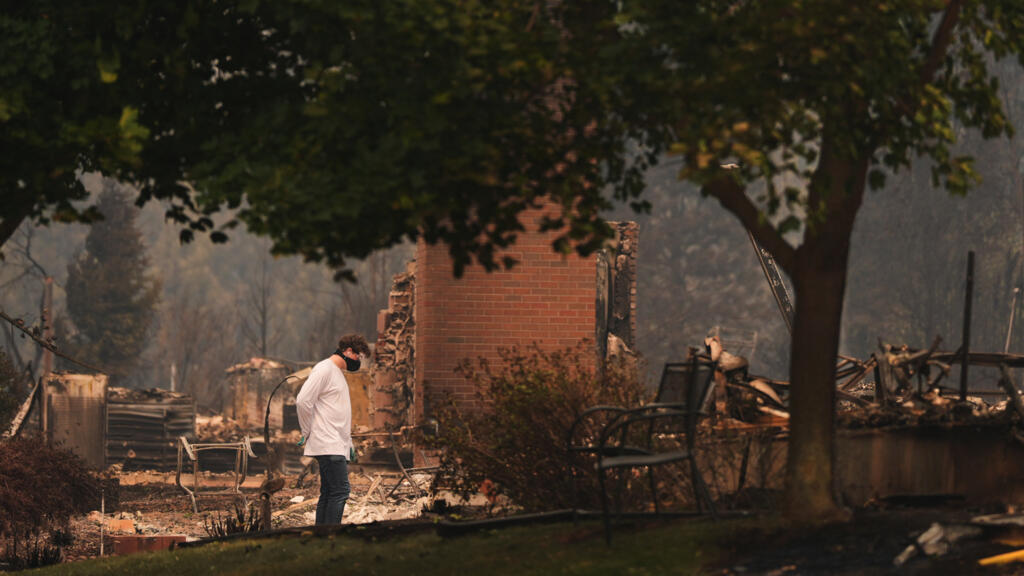 US northwest wildfires force 65,000 to flee as hundreds of buildings burn in Spokane
