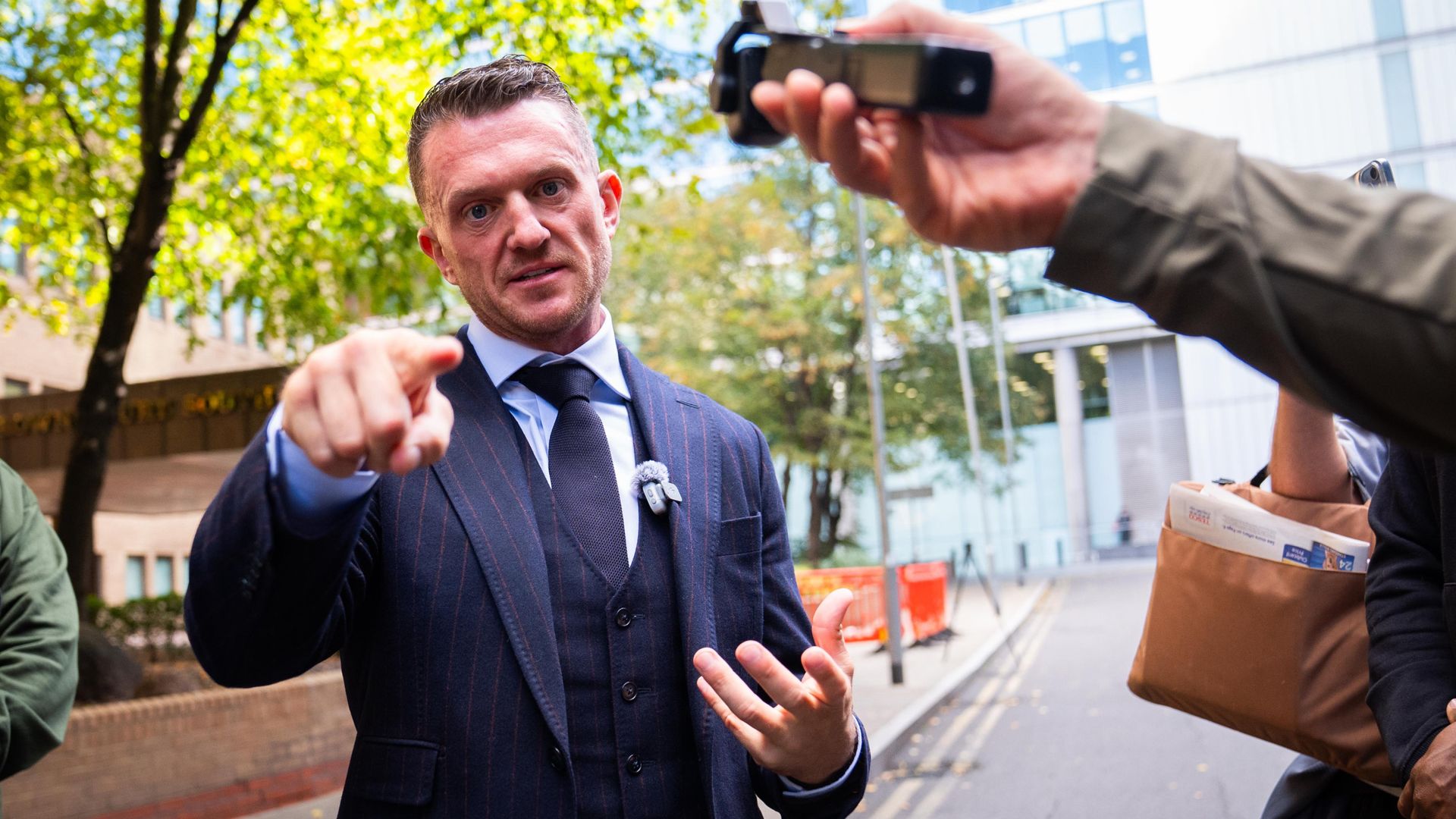 Tommy Robinson appears in court over alleged harassment of two journalists