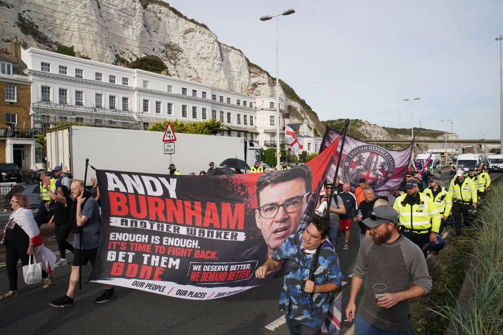 Hundreds gather at anti-migrant protests in two UK port cities