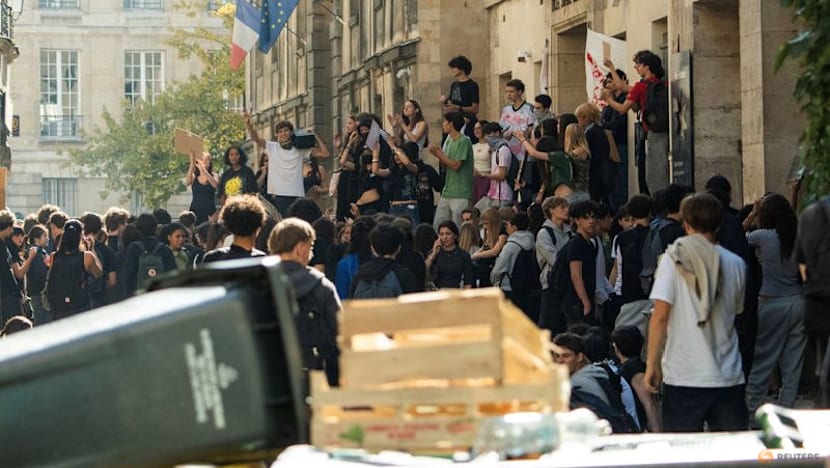 Teenager loses hand picking up grenade in France school protests