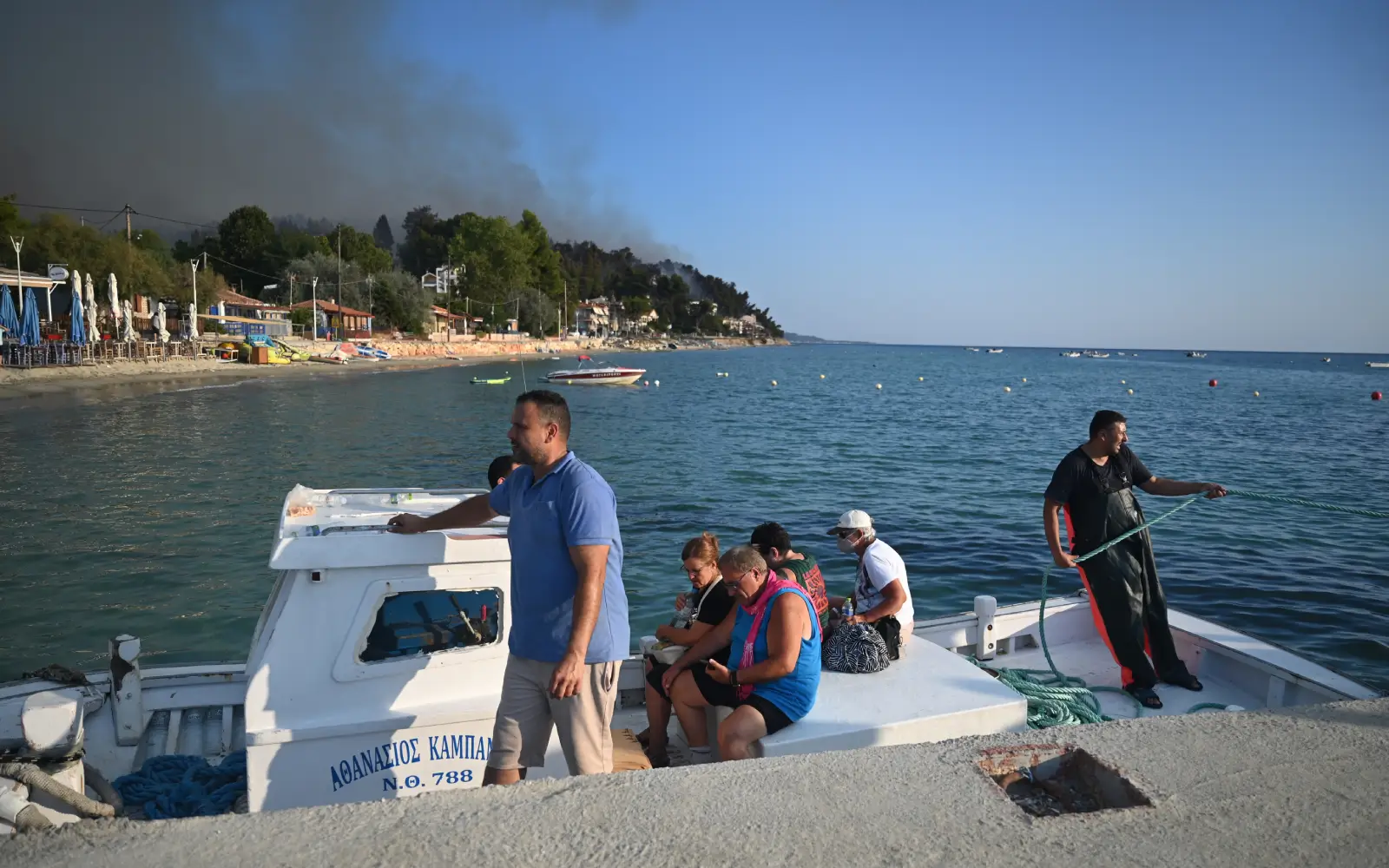 Two dead, hundreds evacuated from fires on island near Athens