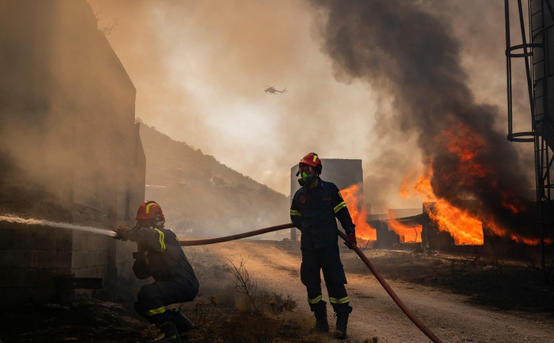 Two dead, hundreds evacuated from fires on island near Athens