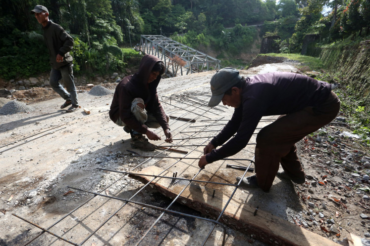 Aceh question slow recovery nearly a year after devastating floods