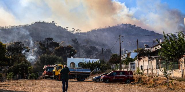 Firefighters battle massive wildfires in Belgium and Greece as two die on island near Athens