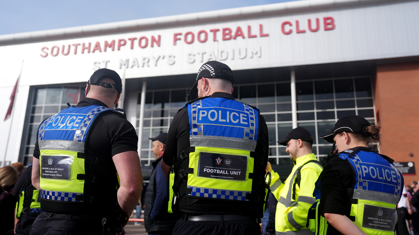 Officer injured as football fans pull down barriers