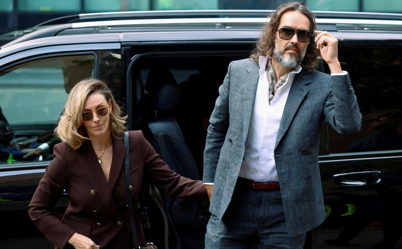 Comedian Russell Brand appears in UK court for start of rape trial