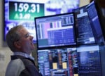 Wall St futures rise as rate hike fears ease; earnings buoy stocks