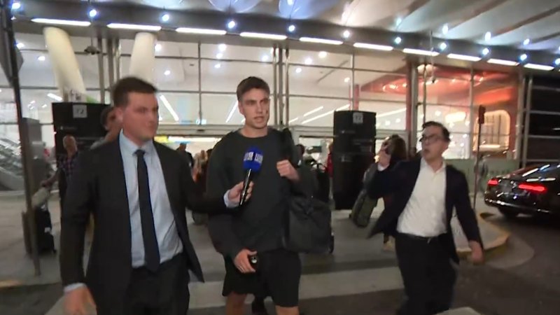 Swans player swarmed at airport