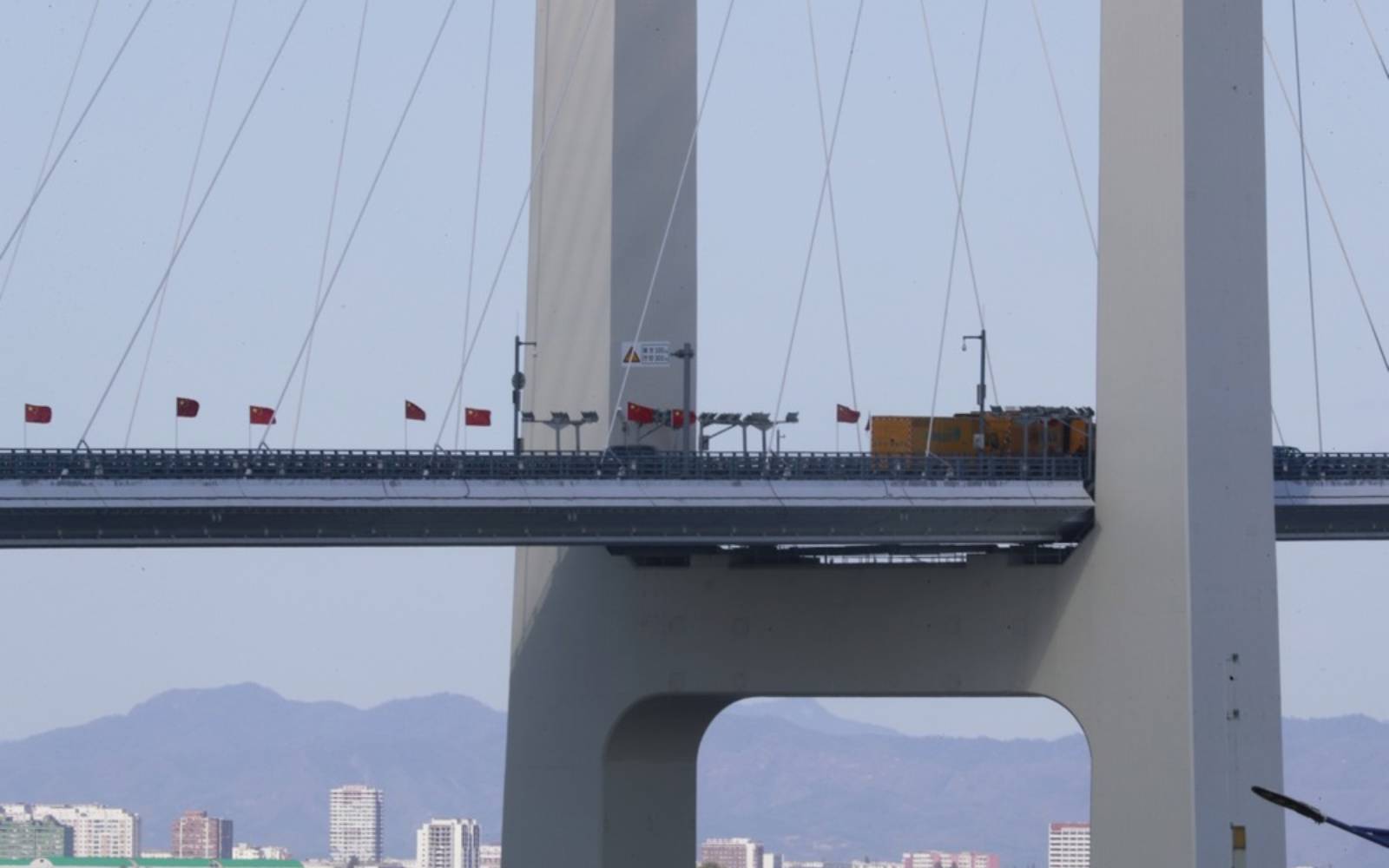 Trucks line up as long-delayed China-North Korea bridge officially opens