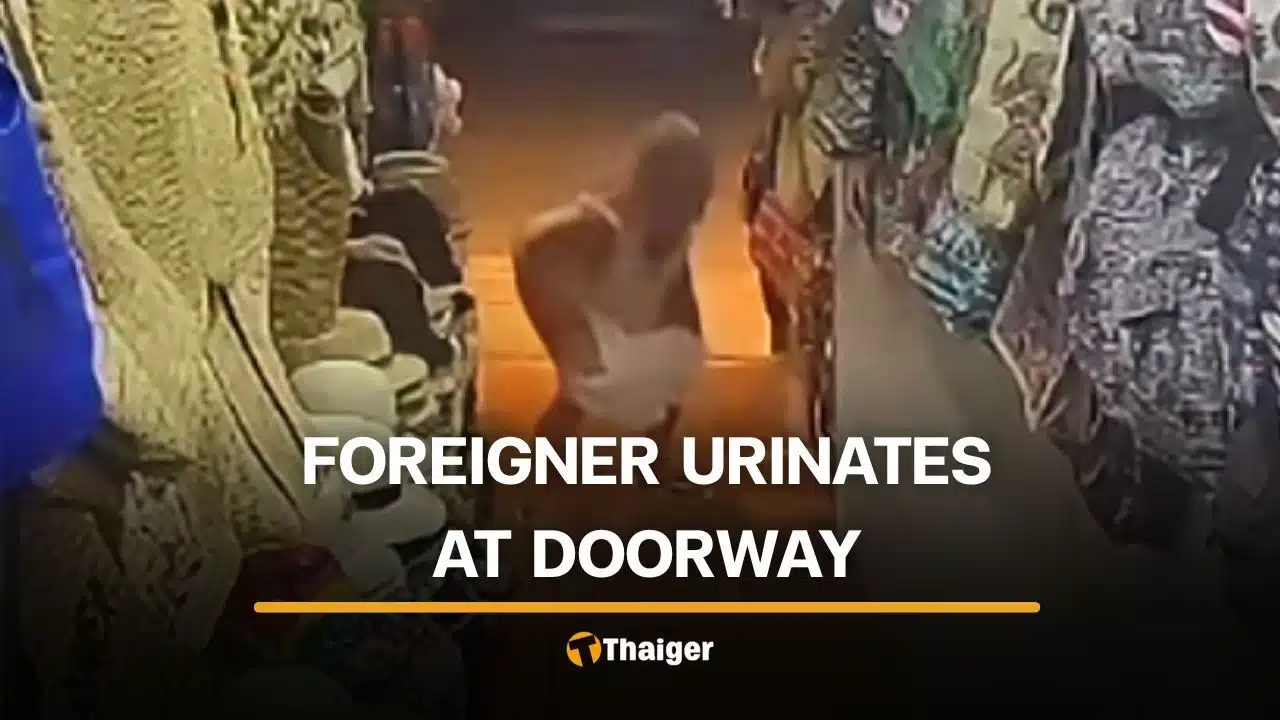 Foreign woman relieves herself at Phuket beachwear shop doorway