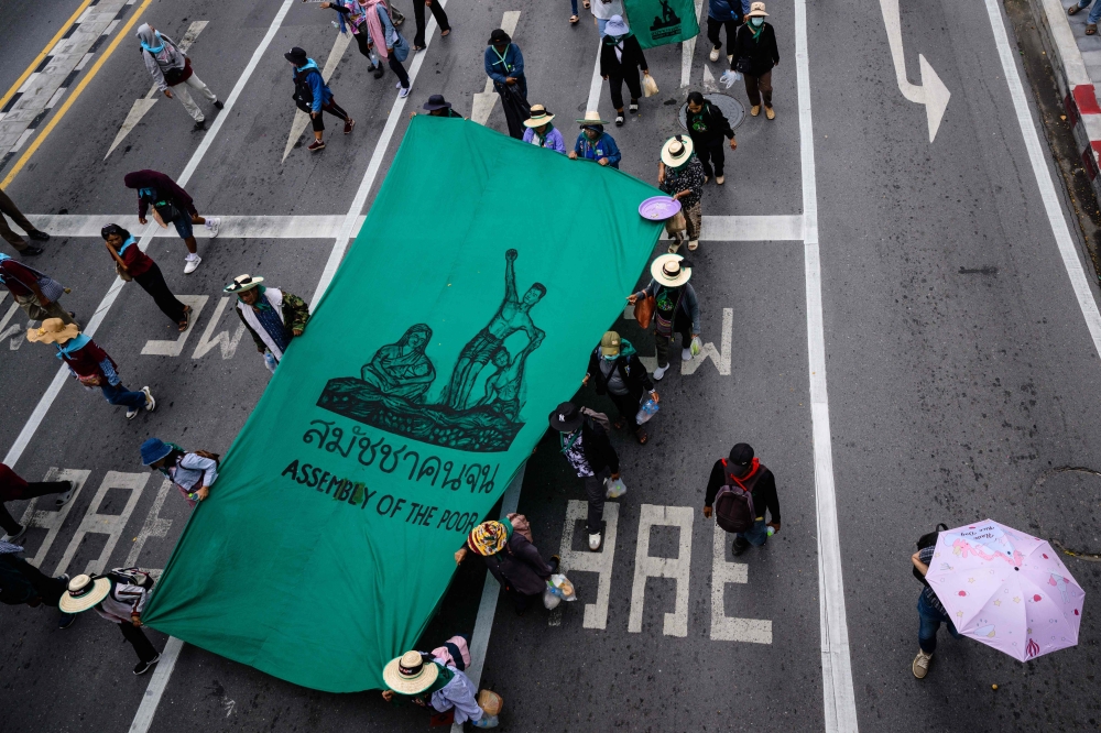 ‘Please don’t make us poorer’: Bangkok protesters challenge IMF, World Bank over spending cuts