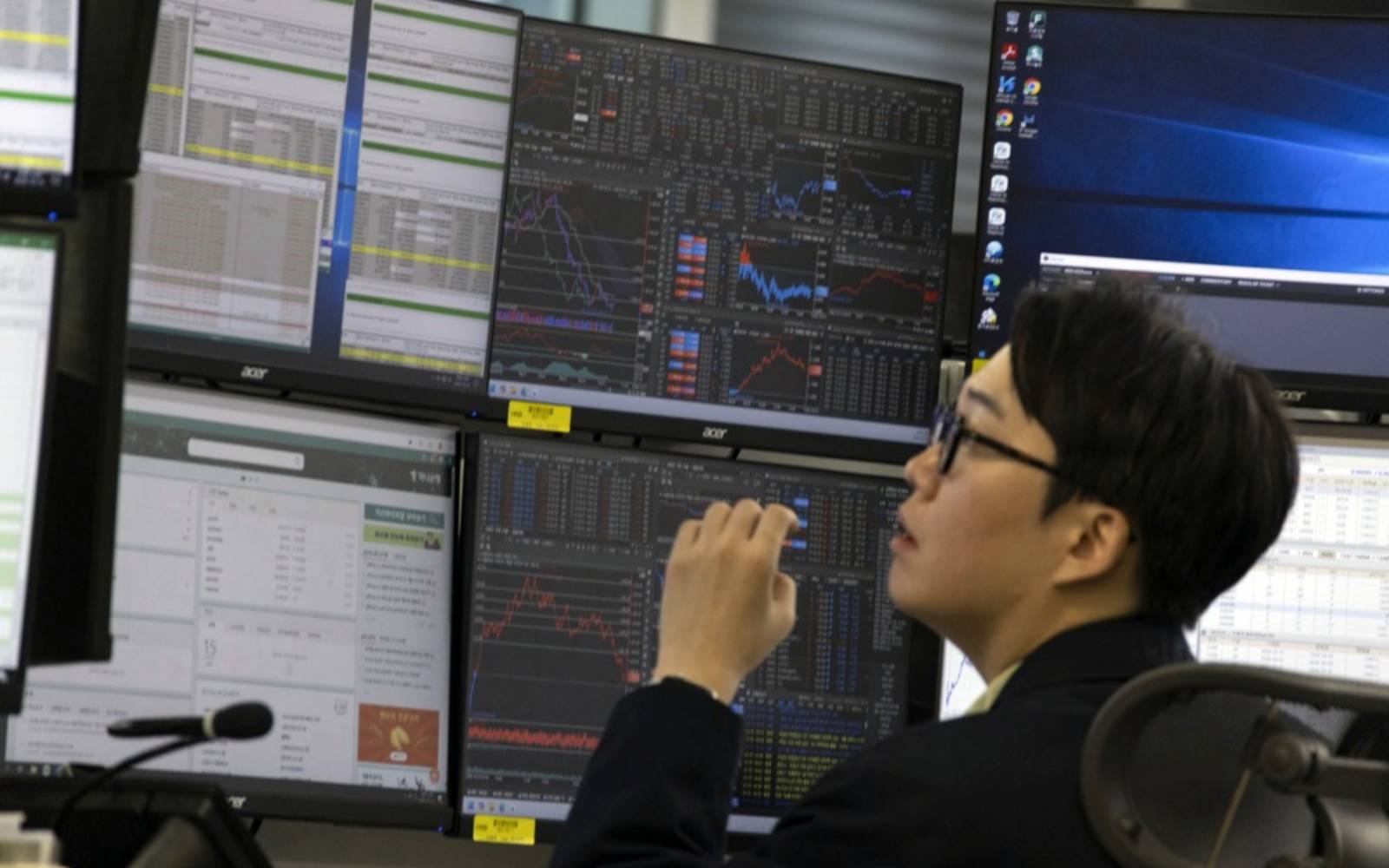 Asian stocks skid, Wall Street and bonds aided by oil slip