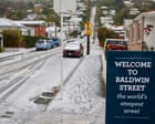 New Zealand capital delights in rare snowfall as southern city residents ski down world’s steepest street