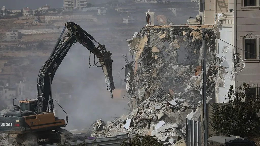 Israeli forces begin demolishing Palestinian buildings in Hebron after two Israeli soldiers shot dead