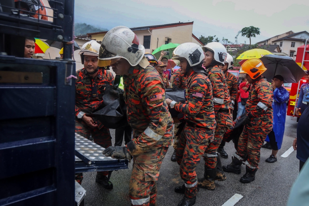 Body of doctor pulled from rubble, residents evacuated after Paya Terubong landslide