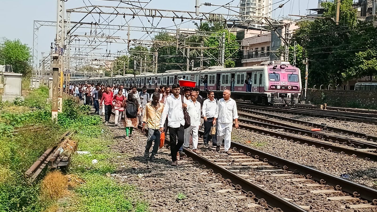 Mumbai local train delayed after multiple technical snags; commuters walk on tracks