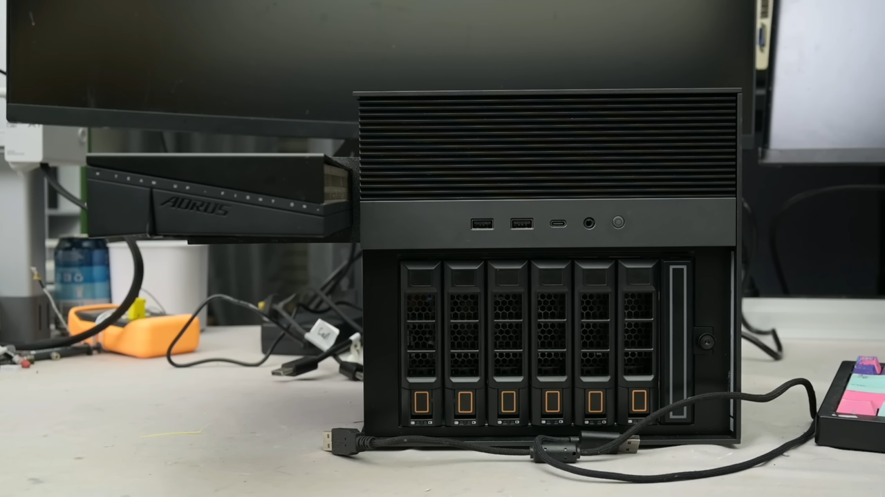 Crazed modder turns NAS into a gaming PC with RTX 5060 hanging from the side, boosts frame rate by 828% — Frankenstein rig hides dedicated PSU in drive bay, breaks Time Spy world record for the onboard CPU