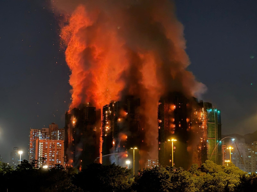 Hong Kong leader apologises for deadly blaze that killed 168 as housing minister resigns over govt failures