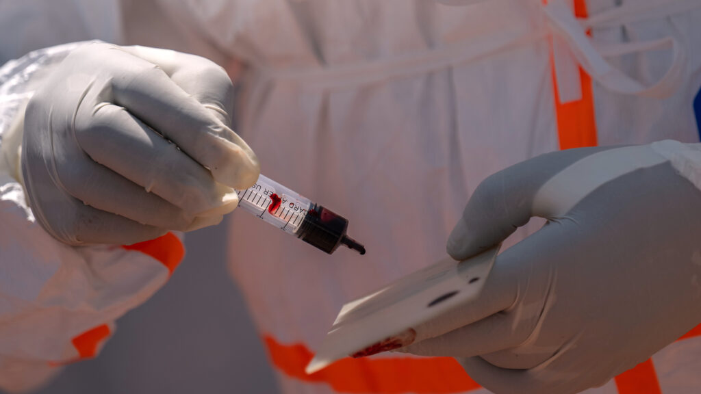Ebola outbreak nears milestone, while a vaccine remains months away