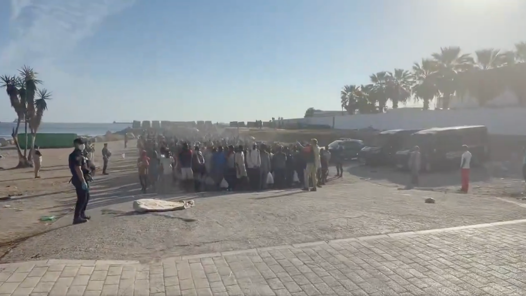 Police move an estimated 4,000 migrants off Ceuta’s sand in dawn operation