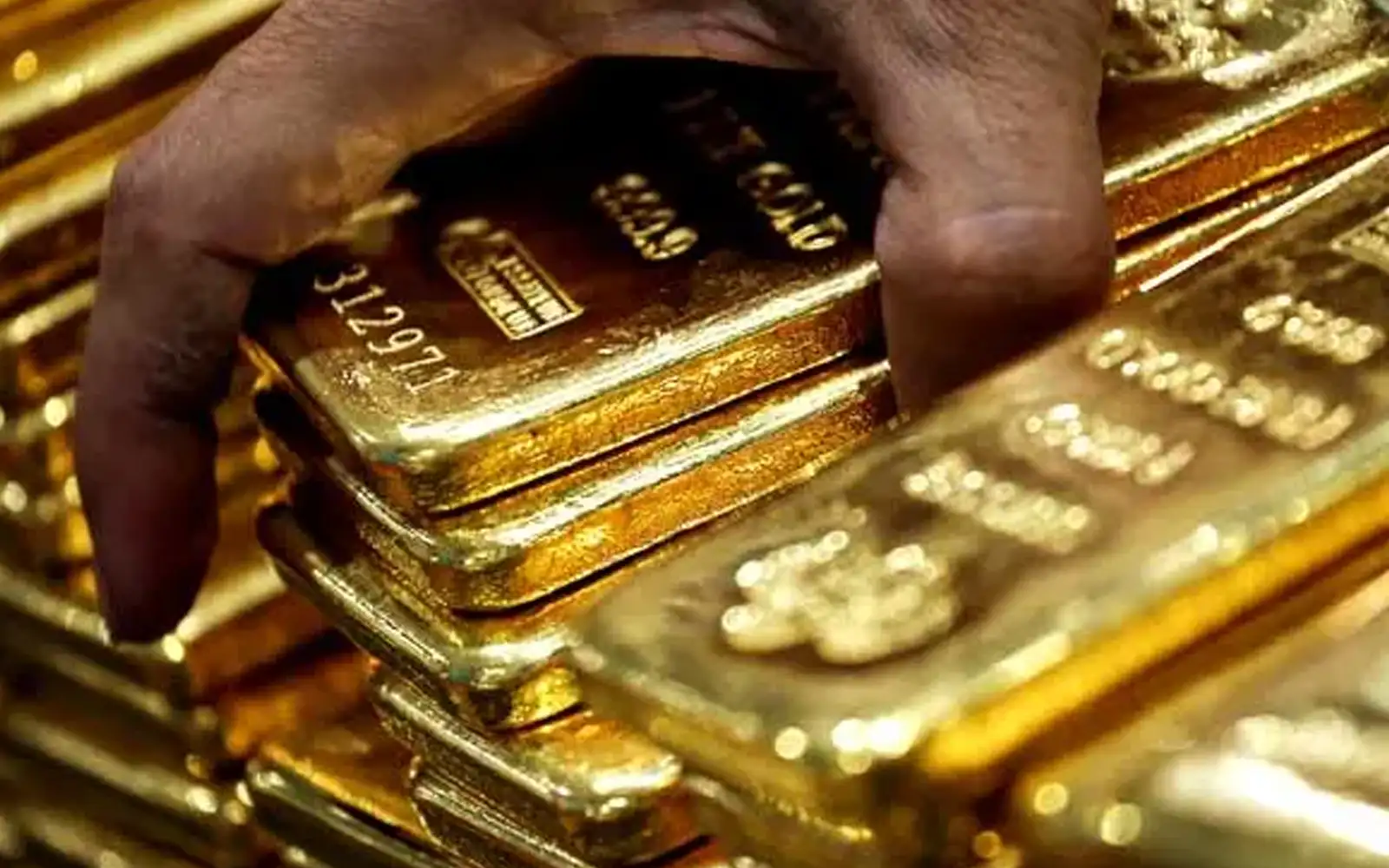 Gold holds near three-month high as debasement trade returns
