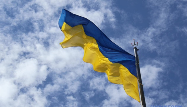 UK and Moldovan Parliament buildings lit up in colors of Ukrainian flag