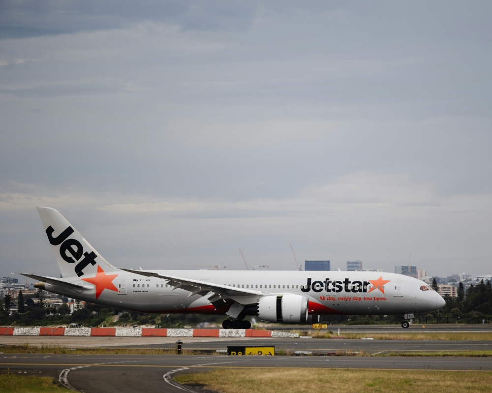Jetstar plane forced to brake hard to avoid Qatar jet at Sydney airport, one crew member injured