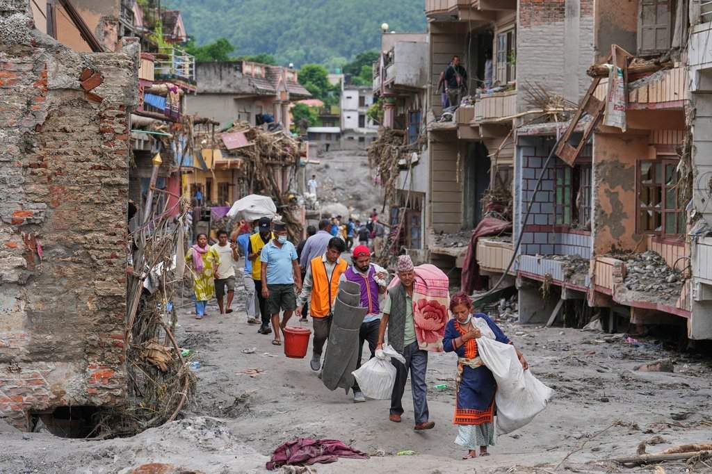 Nepal flood survivors reach safe areas as families await news of missing