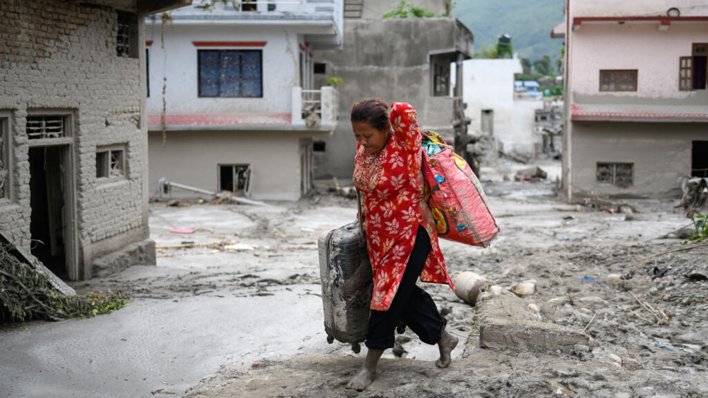 Rescuers claw through mud as missing toll from Nepal, China flood nears 3,000