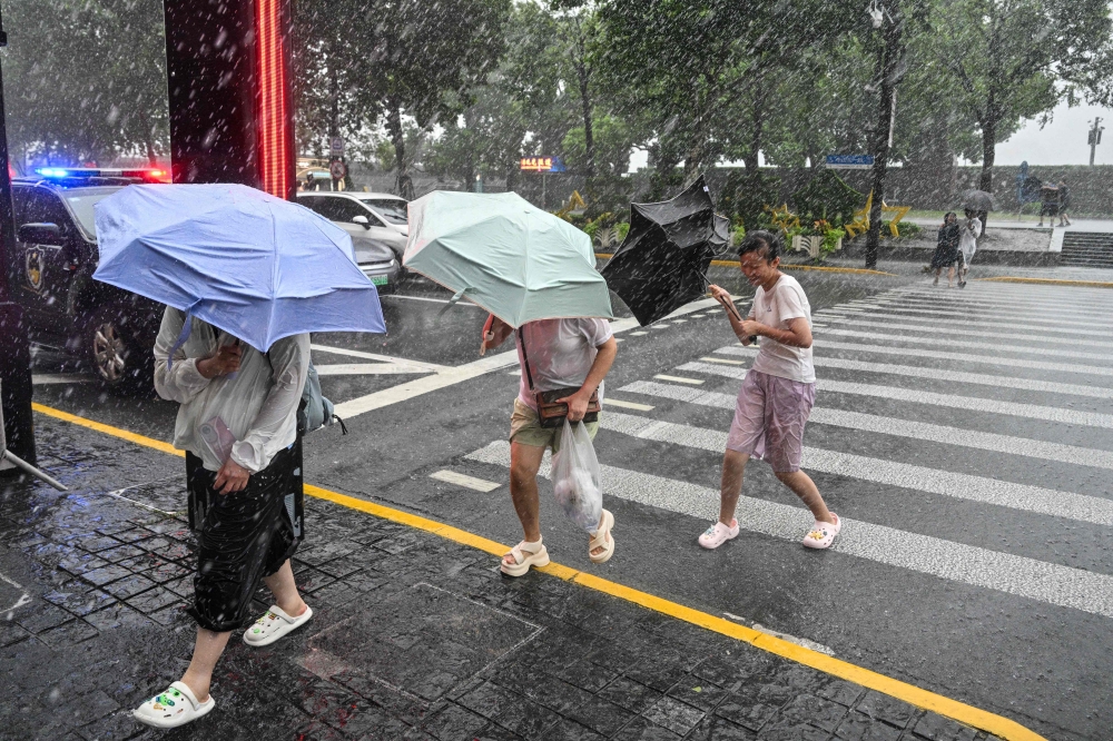 Typhoon Dolphin weakens but leaves hundreds of flights cancelled and flood alerts across China