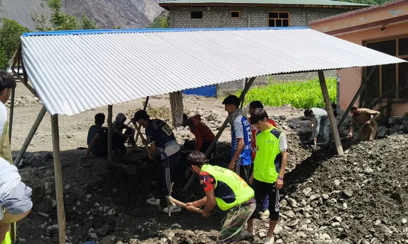 Volunteers clear debris from flood-hit Chitral villages