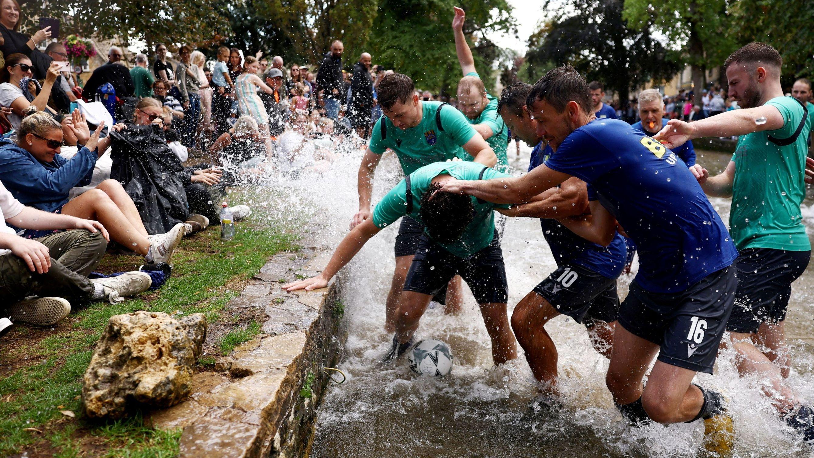Hundreds gather to watch river football match