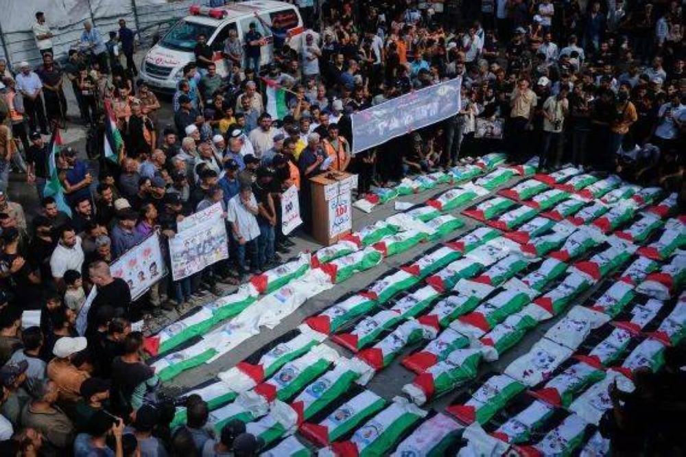 Palestinians in Gaza bury remains of 100 people