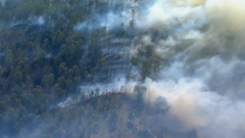 Bushfires burn west of Brisbane in unseasonable heat