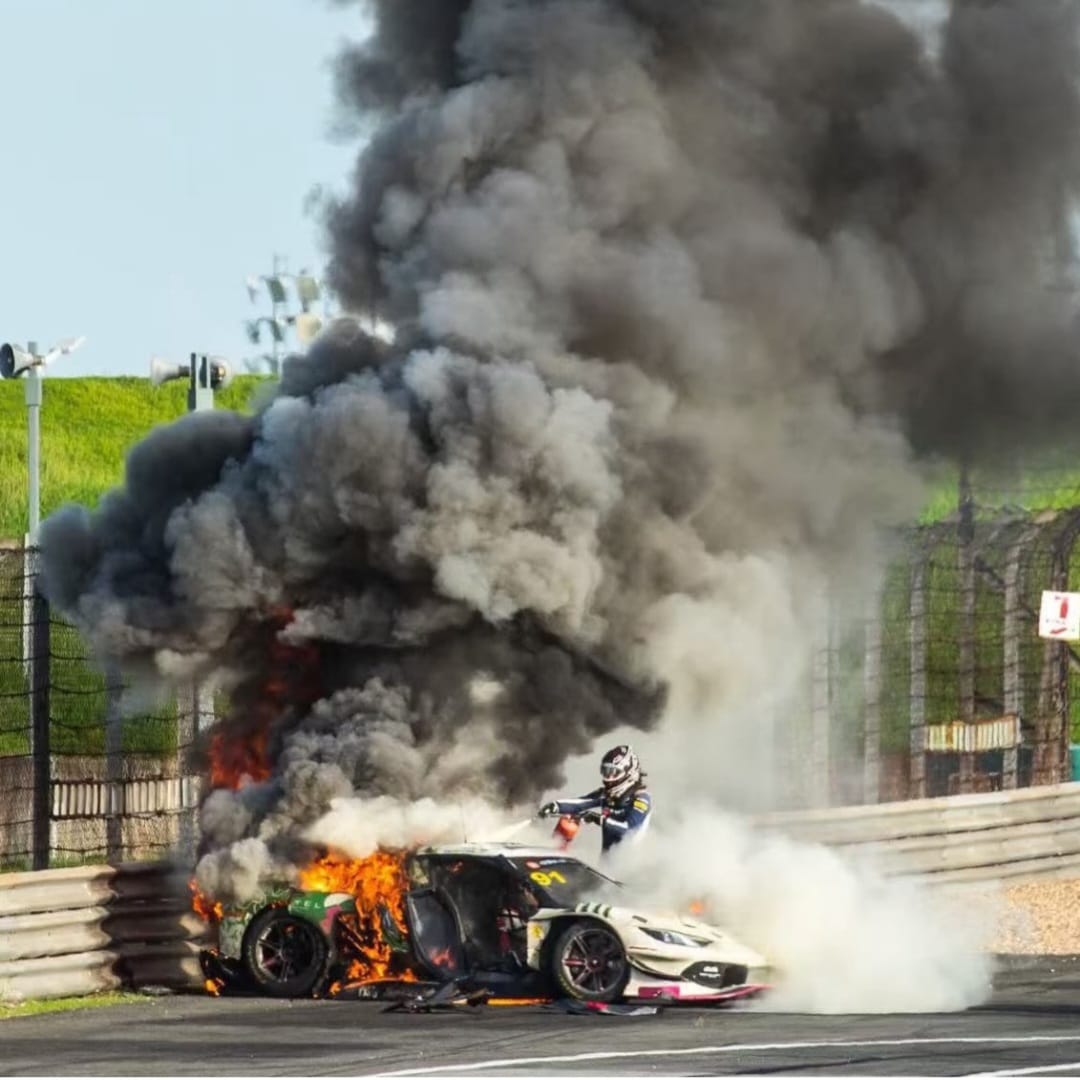 Dicing with death: Racing driver rescues rival from blazing Ferrari wreck