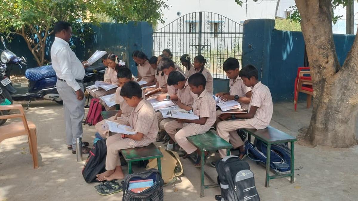 After demolition of school buildings, students of Government Middle school attend classes under tree shade in Vellore
