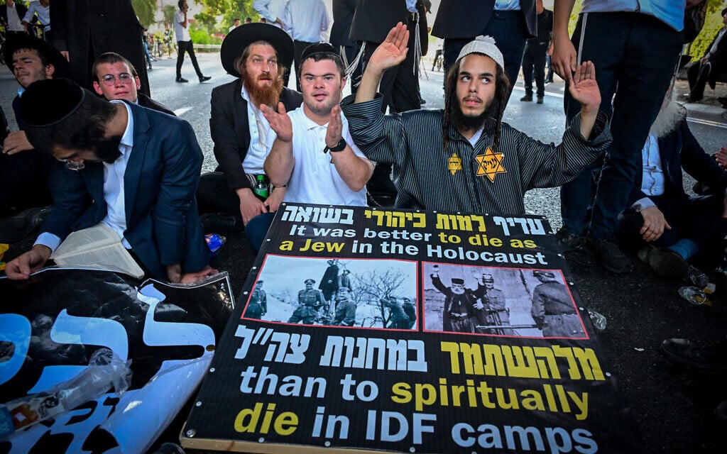 ‘Make the earth shake’: Haredi protesters don yellow stars, block roads after draft evader’s arrest