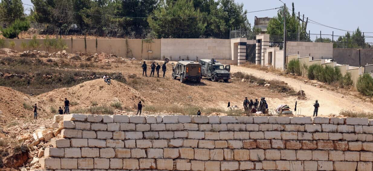 Israeli settlers keep up siege of Palestinian homes in West Bank after clashes with troops