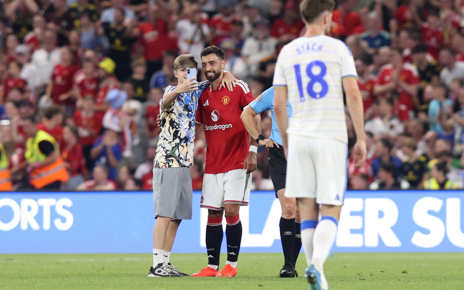 Pitch invaders take selfies with Fernandes during Man Utd friendly
