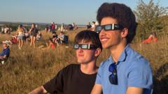 Hundreds gather to watch eclipse on hillside
