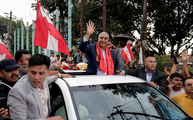 Former Nepal premier Deuba returns home, faces graft probe