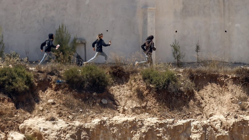 Israeli troops in West Bank homes besieged by settlers