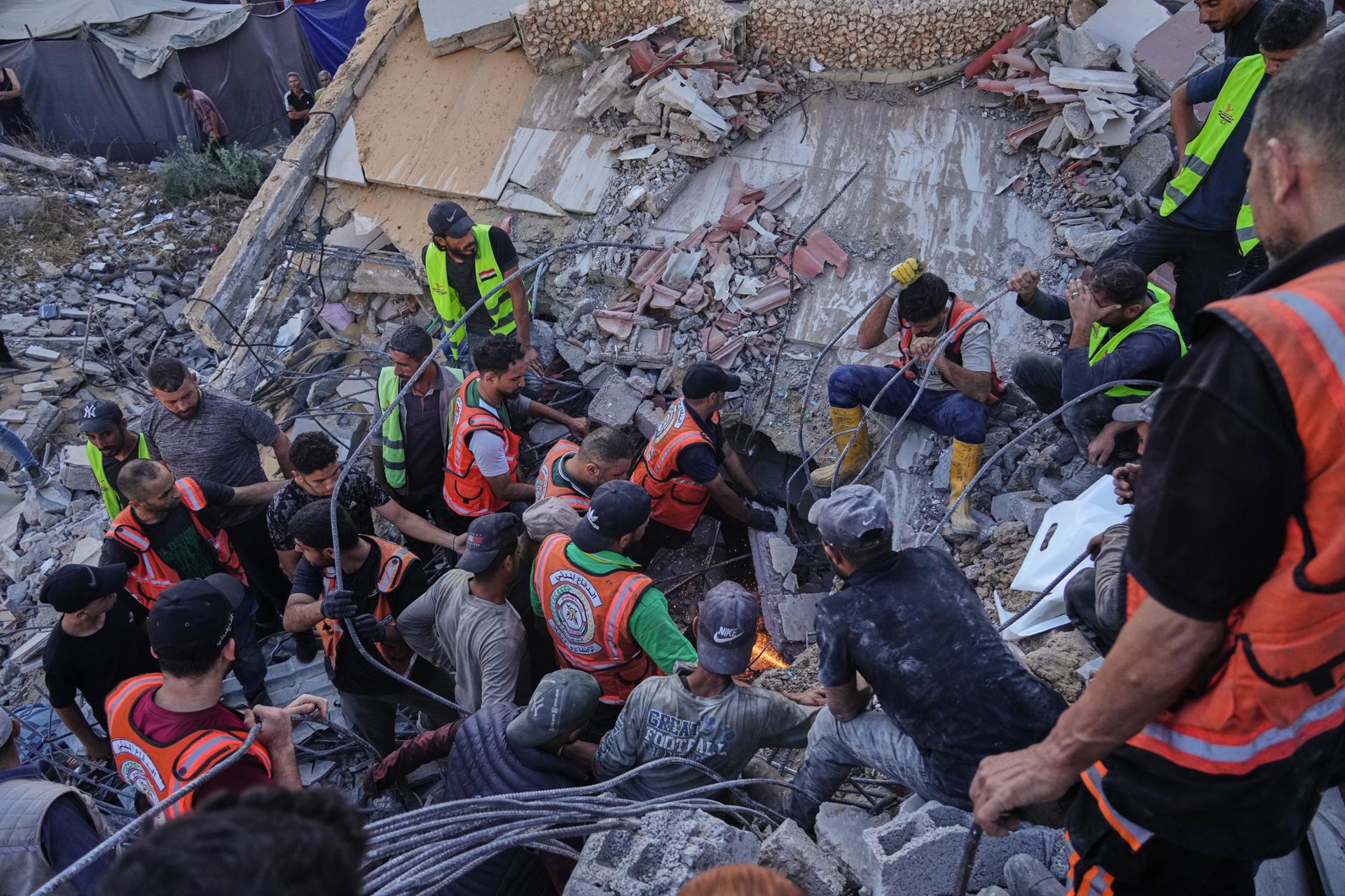 War-damaged Gaza building collapses, killing 12 people seeking shelter inside
