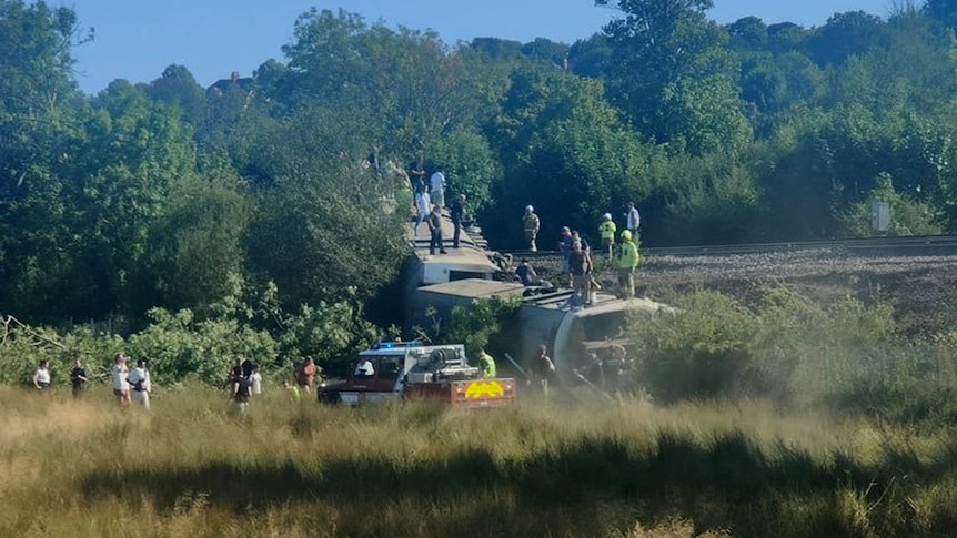 Passenger train derails and flips over in southern England