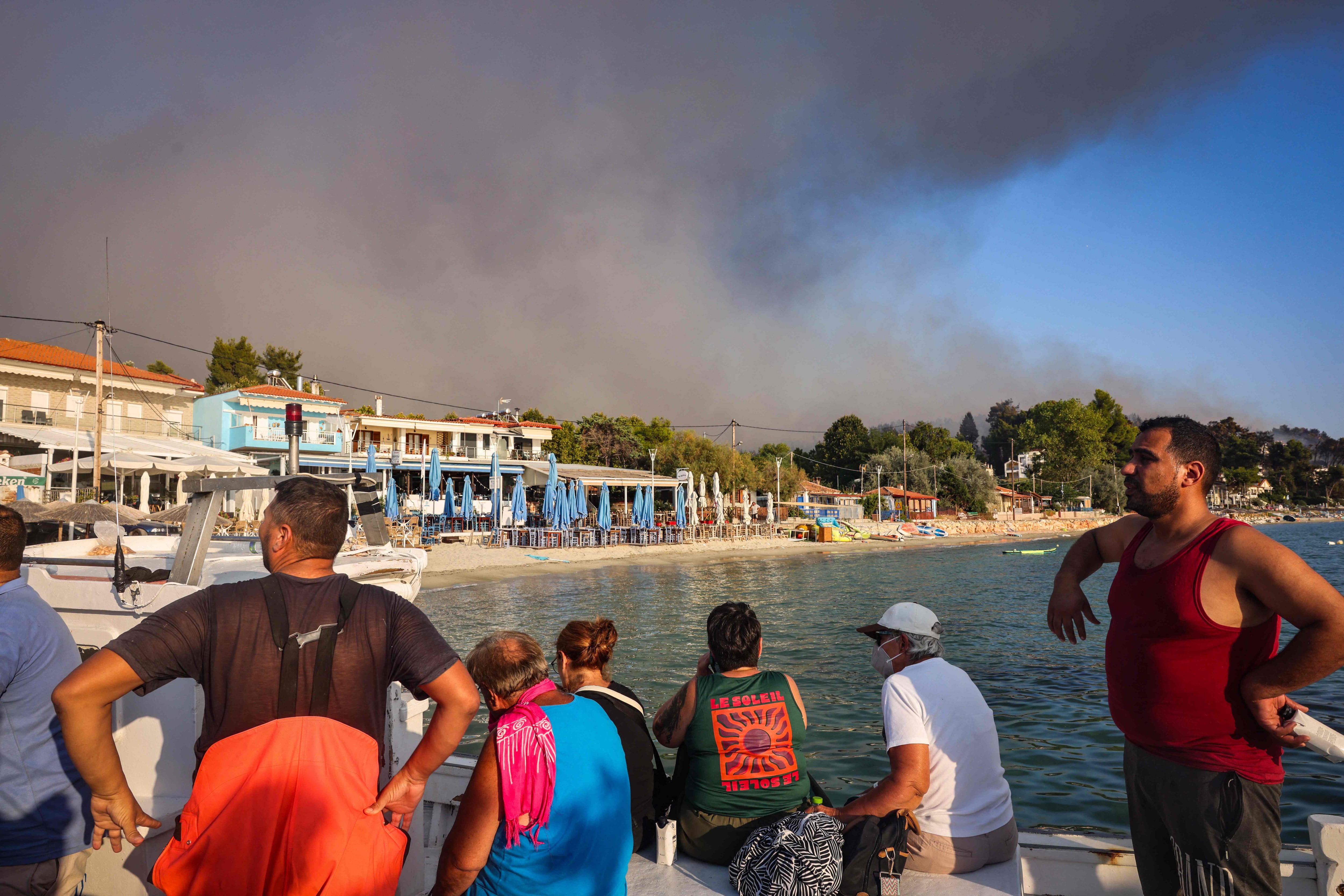 Tourists flee blazes in Greece as fire hits bomb-riddled forest in Germany
