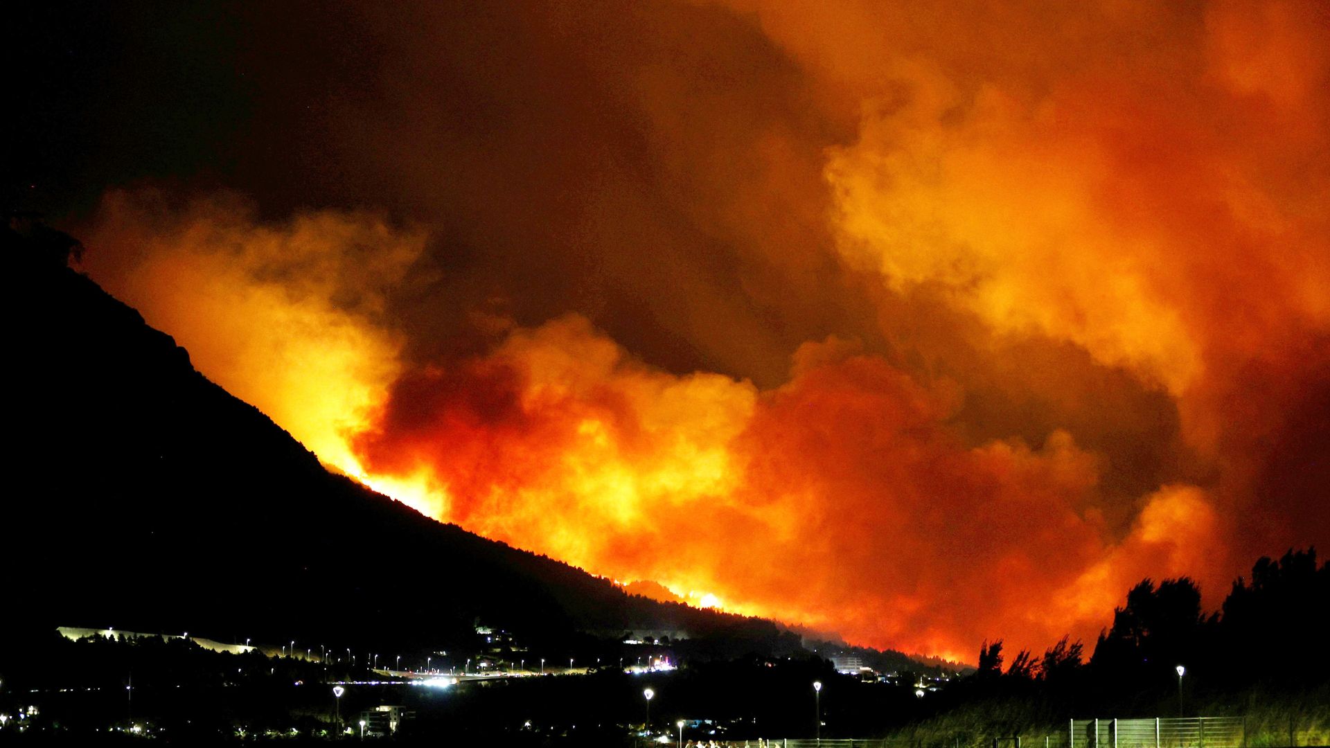 Skies turn red as wildfires burn across Europe - with thousands of people evacuated