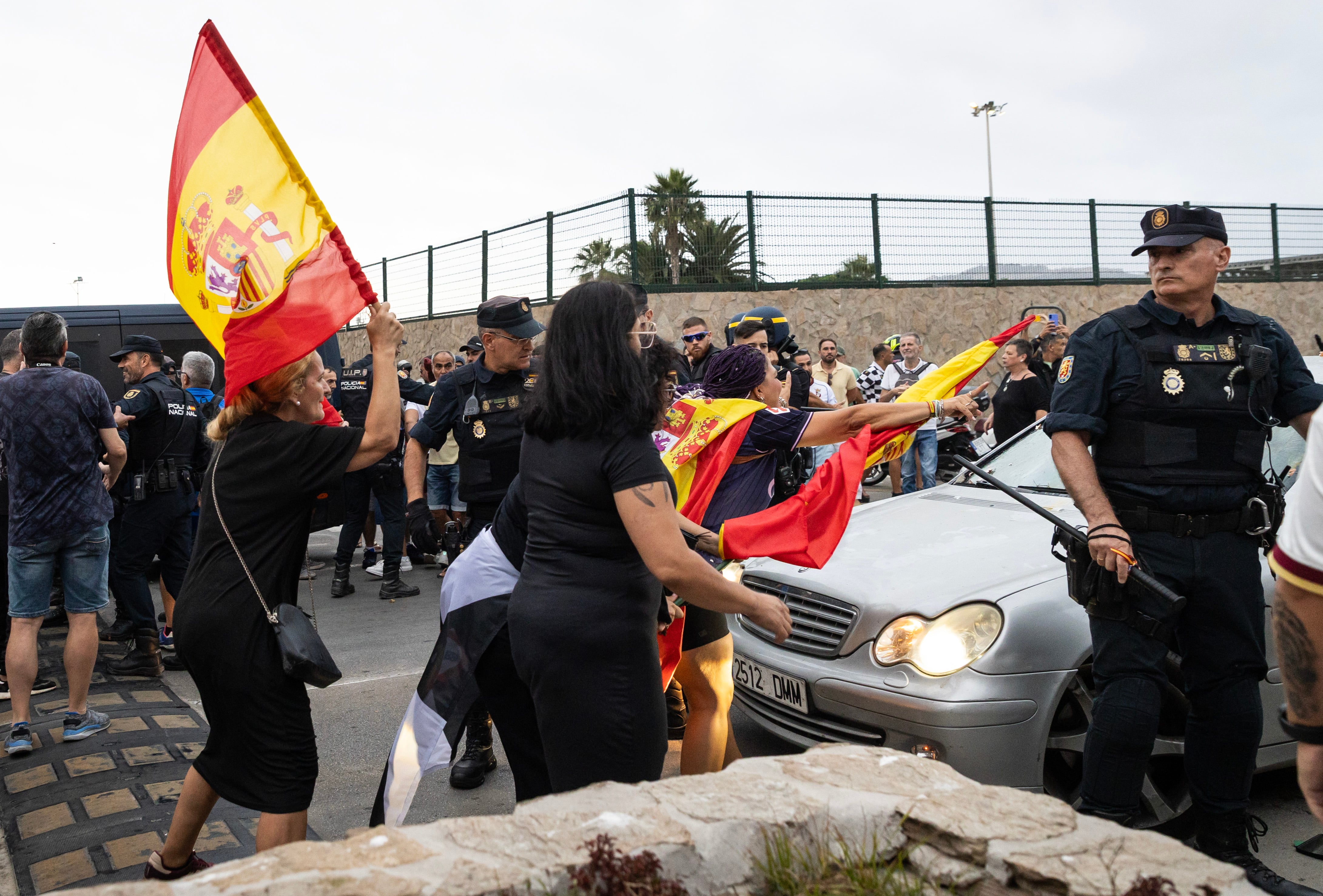 Protesters smash a deputy’s car in Ceuta as she was travelling with an activist