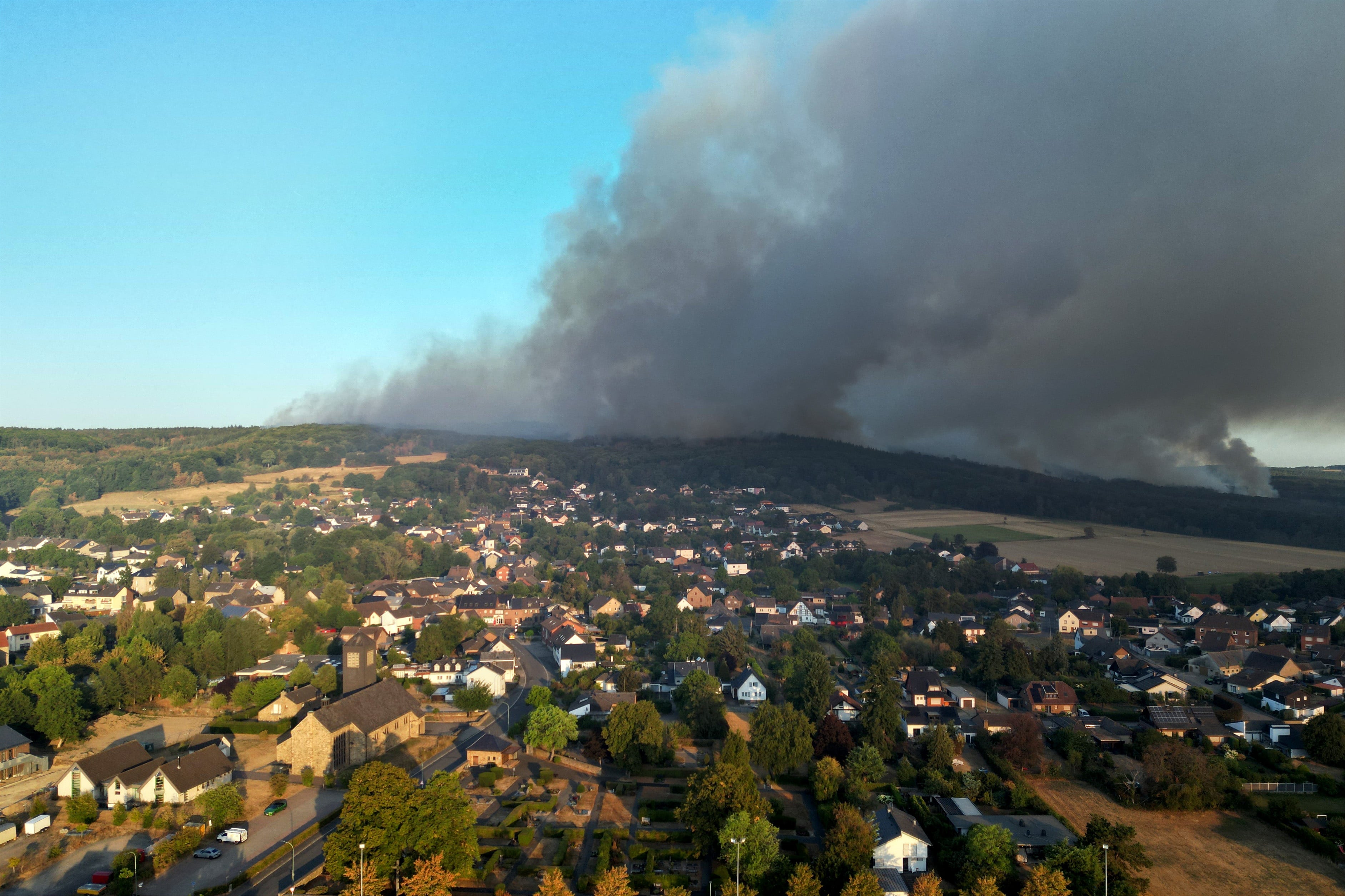 Forest fires in Europe force thousands to be evacuated and cause dozens of injured