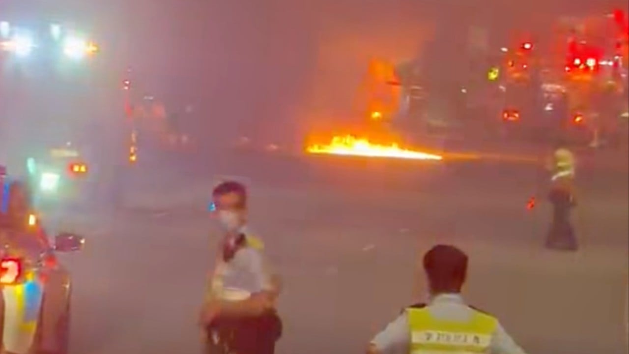 Truck driver flees after vehicle crashes and bursts into flames on Lantau highway