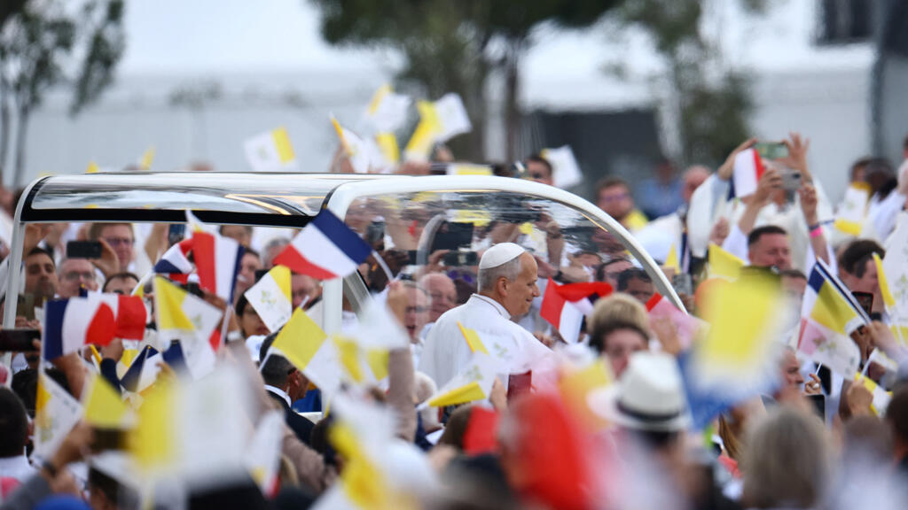 Huge crowds cheer Pope Leo along Champs-Elysees ahead of Paris mass